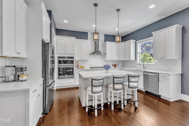 1716 Arberdour Dr, Apex, NC 27502 - kitchen with appliances with stainless steel finishes, wall chimney range hood, white cabinetry, and recessed lighting
