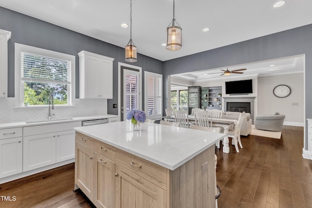 1716 Arberdour Dr, Apex, NC 27502 - kitchen featuring a fireplace, a ceiling fan, a sink, decorative backsplash, and a kitchen island