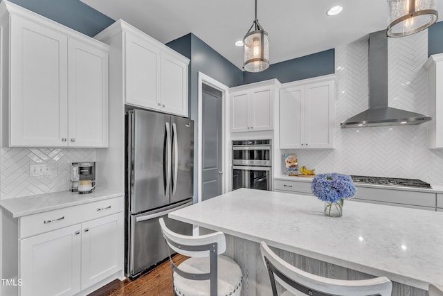 1716 Arberdour Dr, Apex, NC 27502 - kitchen featuring appliances with stainless steel finishes, wall chimney range hood, white cabinets, backsplash, and recessed lighting