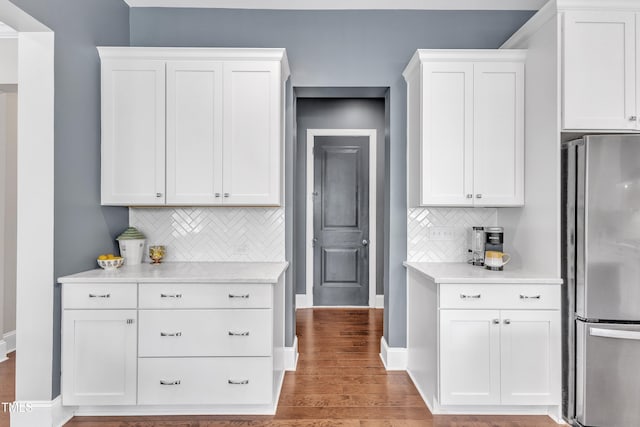 1716 Arberdour Dr, Apex, NC 27502 - kitchen with freestanding refrigerator, light countertops, tasteful backsplash, and white cabinets