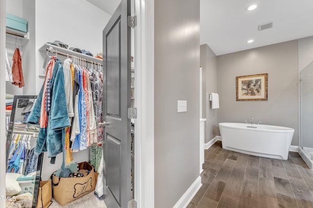 1716 Arberdour Dr, Apex, NC 27502 - full bath featuring a spacious closet, a soaking tub, baseboards, wood finished floors, and recessed lighting