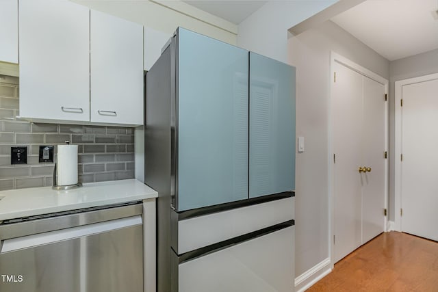 620 Martin Luther King Jr Blvd Unit 302, Chapel Hill, NC 27514 - kitchen with fridge, dishwasher, light countertops, white cabinets, and decorative backsplash