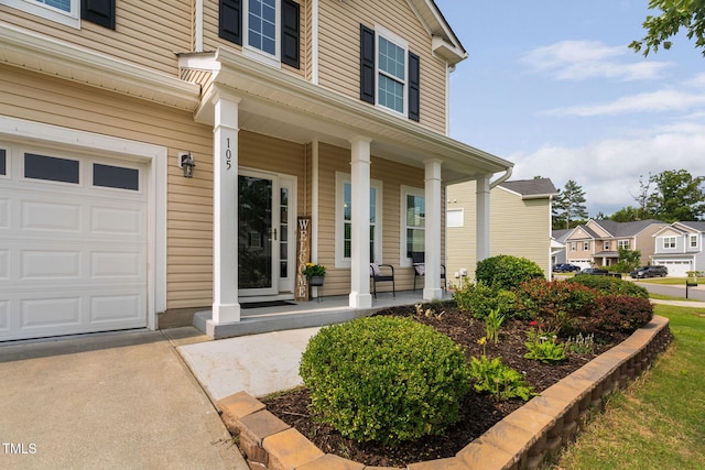 105 Putters Ct, Durham, NC 27703 - doorway to property featuring covered porch, a garage, and a residential view