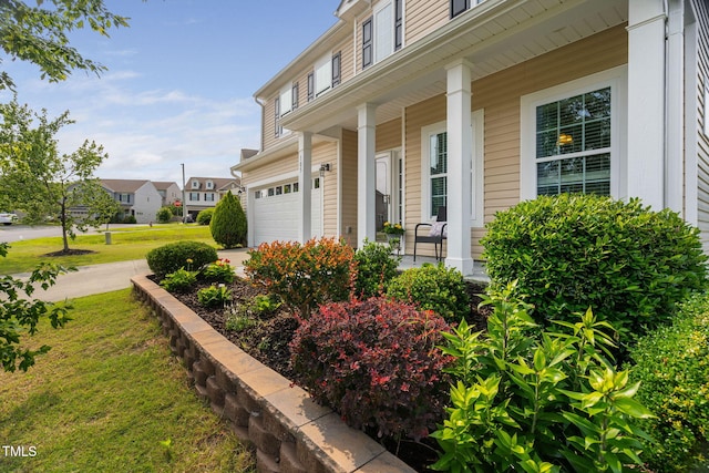 105 Putters Ct, Durham, NC 27703 - entrance to property with a porch, an attached garage, a yard, and a residential view