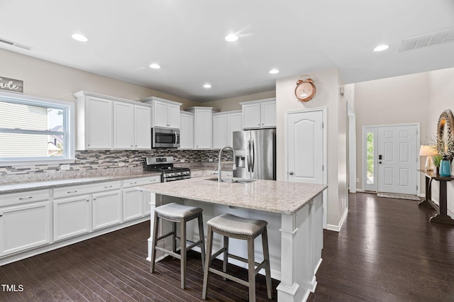 105 Putters Ct, Durham, NC 27703 - kitchen with appliances with stainless steel finishes, white cabinets, plenty of natural light, and recessed lighting