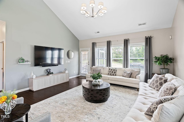105 Putters Ct, Durham, NC 27703 - living area with high vaulted ceiling, a chandelier, and dark wood-style floors