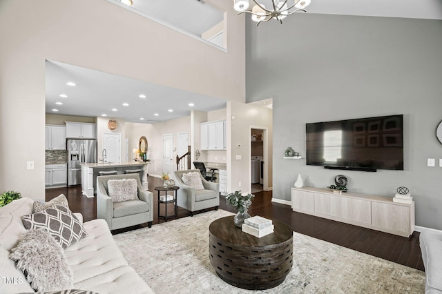 105 Putters Ct, Durham, NC 27703 - living area with dark wood-style flooring, a chandelier, and a towering ceiling