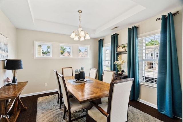 105 Putters Ct, Durham, NC 27703 - dining room with a raised ceiling, a chandelier, and dark wood-style floors