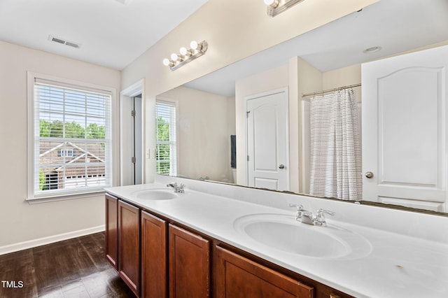 105 Putters Ct, Durham, NC 27703 - full bathroom featuring double vanity and wood finished floors