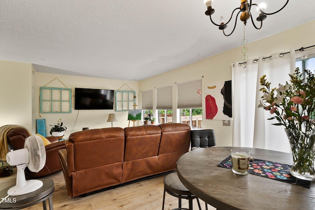 5931 Farm Gate Rd, Raleigh, NC 27606 - living room with a chandelier, light wood-style floors, and a textured ceiling