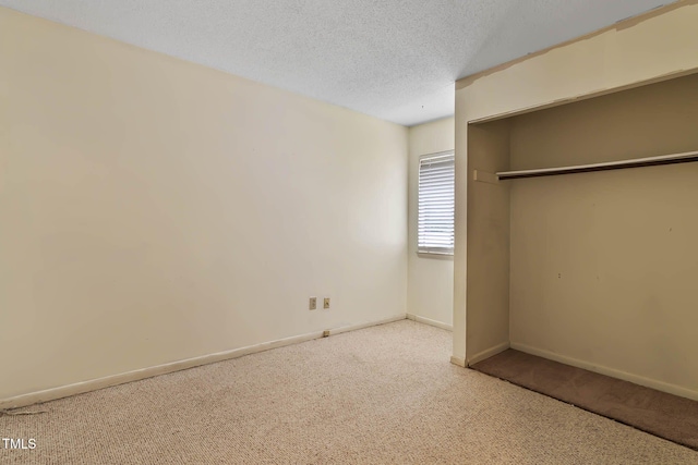 5931 Farm Gate Rd, Raleigh, NC 27606 - unfurnished bedroom featuring carpet, baseboards, a closet, and a textured ceiling