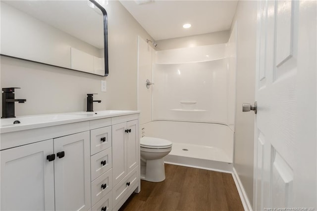 1117 Turnpike Rd, Fayetteville, NC 28305 - full bath featuring wood finished floors, toilet, double vanity, a shower, and recessed lighting