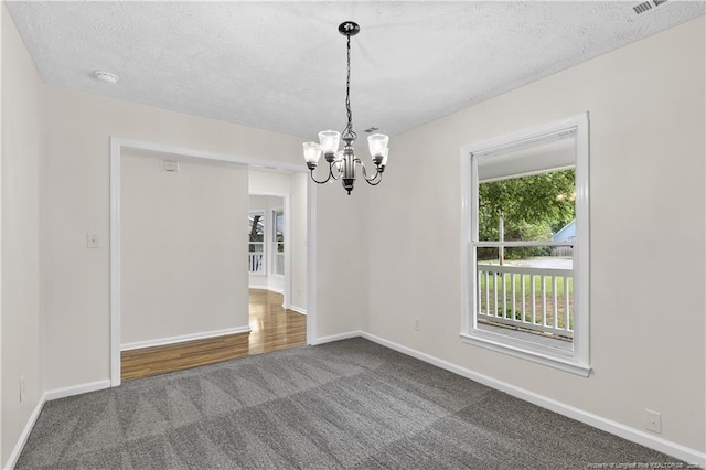 6241 Hedingham Dr, Hope Mills, NC 28348 - carpeted spare room with a chandelier, baseboards, a smoke detector, and a textured ceiling