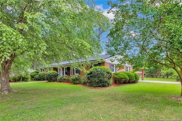 687 Blawell St, Stedman, NC 28391 - ranch-style home with a front lawn and brick siding