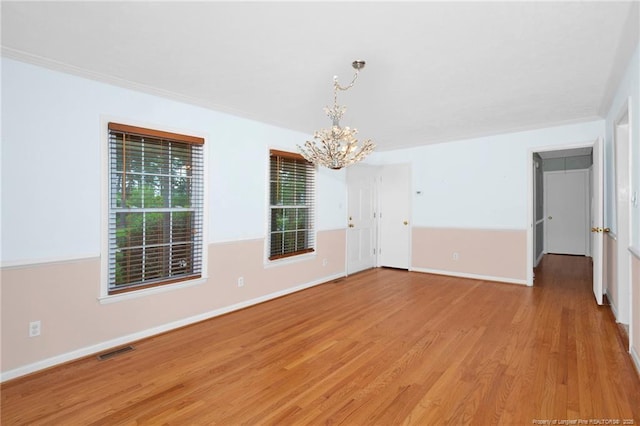 687 Blawell St, Stedman, NC 28391 - empty room with a chandelier, light wood-style floors, and baseboards