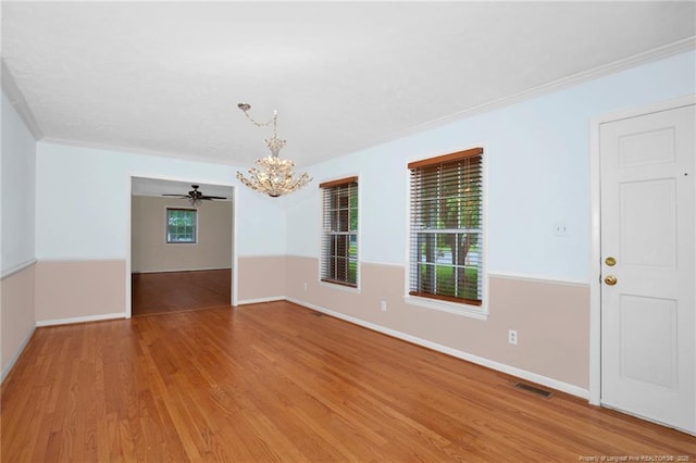 687 Blawell St, Stedman, NC 28391 - unfurnished room with a chandelier, light wood-style flooring, baseboards, and ornamental molding