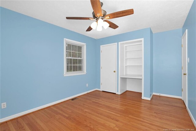 687 Blawell St, Stedman, NC 28391 - unfurnished bedroom with baseboards, light wood-style flooring, and ceiling fan