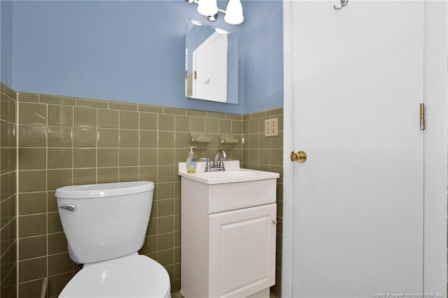687 Blawell St, Stedman, NC 28391 - bathroom featuring tile walls, vanity, toilet, and a wainscoted wall