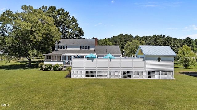 200 Mint Ct, Goldsboro, NC 27530 - back of house with a lawn, a sunroom, and a chimney