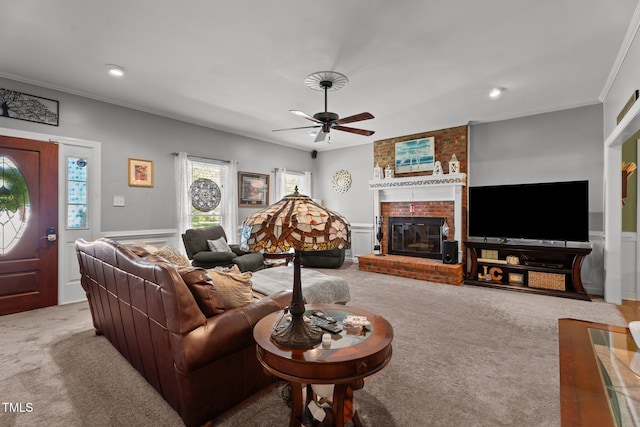 200 Mint Ct, Goldsboro, NC 27530 - living room with carpet, ceiling fan, crown molding, a brick fireplace, and a wainscoted wall
