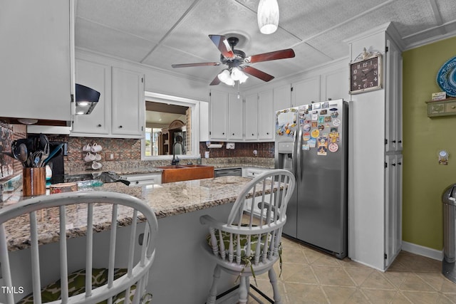 200 Mint Ct, Goldsboro, NC 27530 - kitchen with stainless steel refrigerator with ice dispenser, ceiling fan, white cabinets, decorative backsplash, and a peninsula
