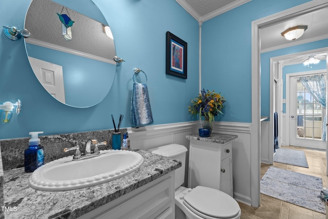 200 Mint Ct, Goldsboro, NC 27530 - bathroom featuring toilet, vanity, wainscoting, a textured ceiling, and crown molding
