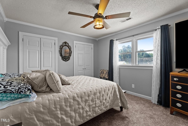 200 Mint Ct, Goldsboro, NC 27530 - bedroom featuring carpet floors, two closets, ornamental molding, a textured ceiling, and a ceiling fan