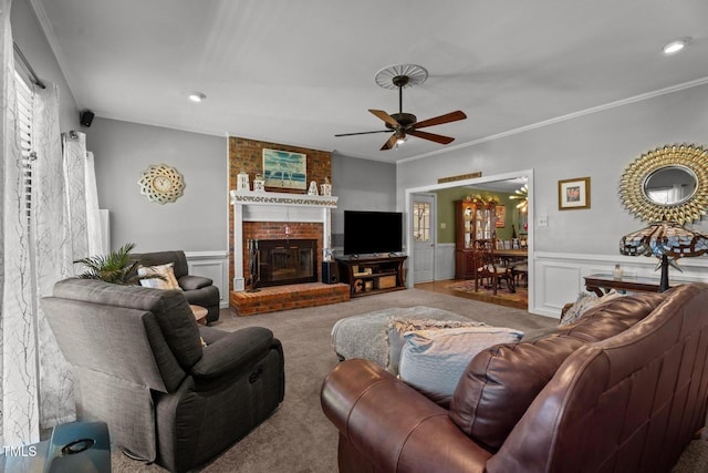 200 Mint Ct, Goldsboro, NC 27530 - living room with carpet flooring, ornamental molding, ceiling fan, a wainscoted wall, and a fireplace