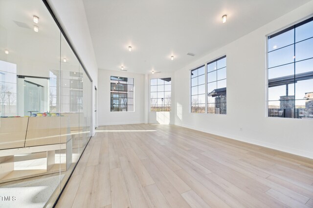 880 Cassa Clubhouse Way, Knightdale, NC 27545 - unfurnished living room with light wood-style flooring and baseboards