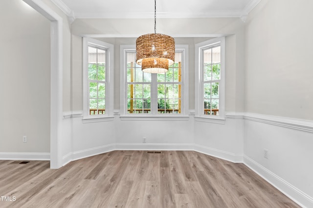 2015 Saddlebrook Dr, Archer Lodge, NC 27527 - unfurnished dining area with a chandelier, light wood-type flooring, ornamental molding, and baseboards