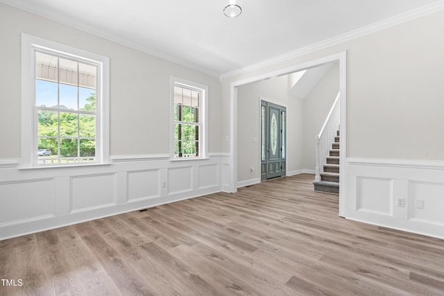2015 Saddlebrook Dr, Archer Lodge, NC 27527 - spare room with crown molding, stairs, a wainscoted wall, a decorative wall, and wood finished floors