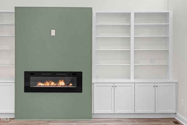 2015 Saddlebrook Dr, Archer Lodge, NC 27527 - detailed view of a glass covered fireplace and wood finished floors