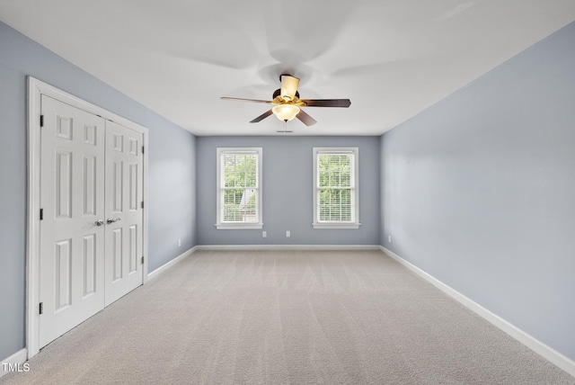 704 Walcott Way, Cary, NC 27519 - unfurnished bedroom featuring baseboards, carpet floors, a closet, and a ceiling fan