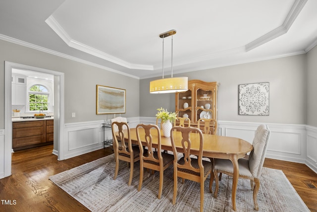 704 Walcott Way, Cary, NC 27519 - dining room with ornamental molding, dark wood-style floors, wainscoting, and a tray ceiling