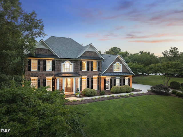 704 Walcott Way, Cary, NC 27519 - colonial-style house featuring a yard, brick siding, and a standing seam roof