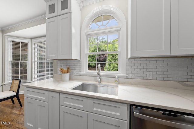 704 Walcott Way, Cary, NC 27519 - kitchen featuring stainless steel dishwasher, a sink, crown molding, white cabinets, and plenty of natural light