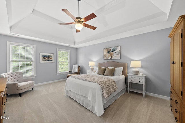 704 Walcott Way, Cary, NC 27519 - bedroom featuring a raised ceiling, baseboards, light carpet, and multiple windows