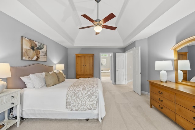 704 Walcott Way, Cary, NC 27519 - bedroom with a raised ceiling, light colored carpet, ensuite bathroom, vaulted ceiling, and baseboards