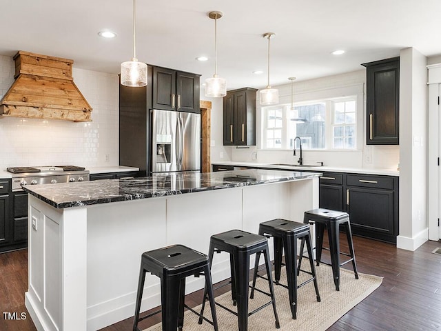 1625 Haystack Ln, Burlington, NC 27217 - kitchen featuring stainless steel fridge, a sink, premium range hood, decorative backsplash, and a center island