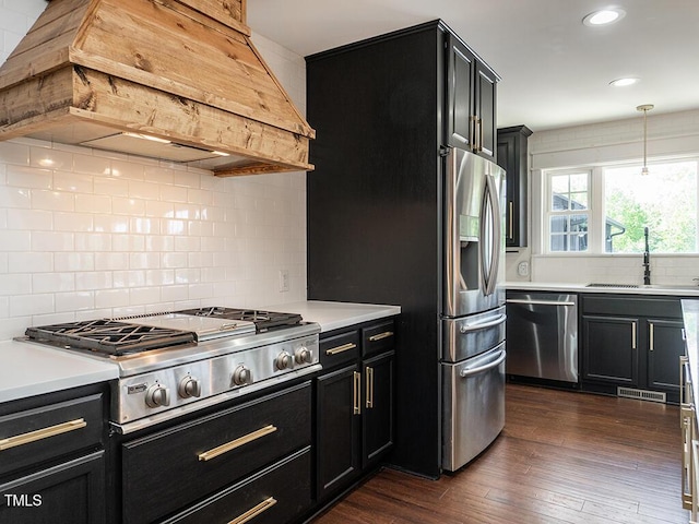 1625 Haystack Ln, Burlington, NC 27217 - kitchen featuring stainless steel appliances, custom exhaust hood, a sink, dark cabinetry, and tasteful backsplash