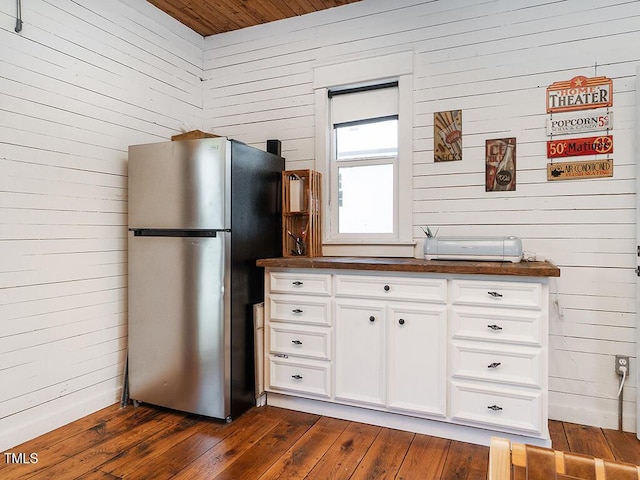 1625 Haystack Ln, Burlington, NC 27217 - kitchen featuring freestanding refrigerator, wood walls, dark wood-type flooring, white cabinetry, and wooden ceiling