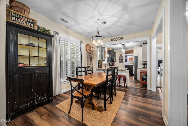 4409 All Points View Way, Raleigh, NC 27614 - dining space featuring a chandelier, dark wood-style floors, and baseboards