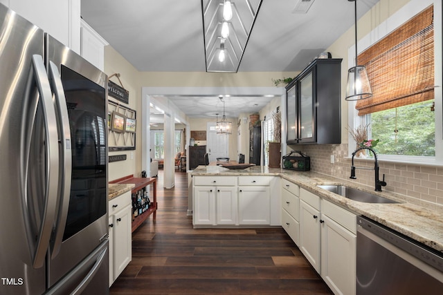 4409 All Points View Way, Raleigh, NC 27614 - kitchen featuring stainless steel appliances, a sink, dark wood finished floors, a chandelier, and a peninsula