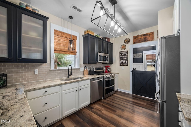4409 All Points View Way, Raleigh, NC 27614 - kitchen featuring stainless steel appliances, a sink, dark wood-style floors, decorative backsplash, and light stone countertops