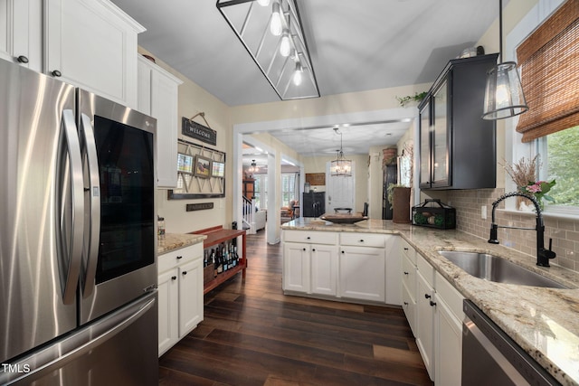 4409 All Points View Way, Raleigh, NC 27614 - kitchen with stainless steel appliances, a sink, dark wood finished floors, a peninsula, and a chandelier
