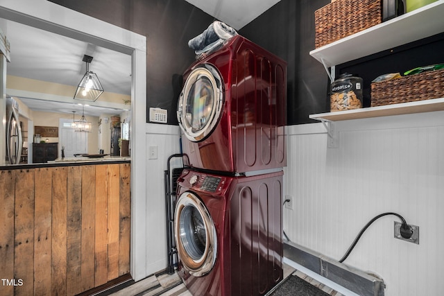 4409 All Points View Way, Raleigh, NC 27614 - washroom featuring stacked washer and clothes dryer and a wainscoted wall