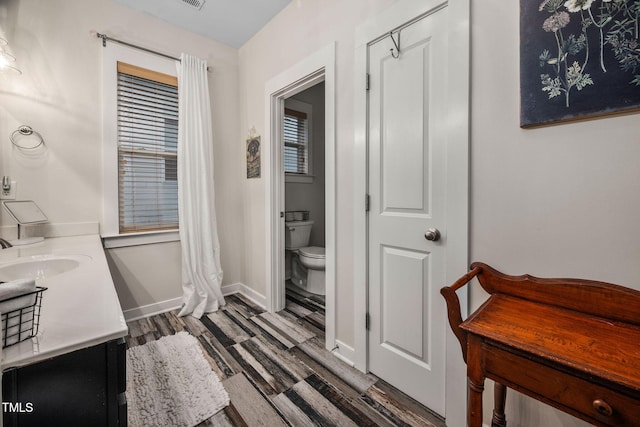 4409 All Points View Way, Raleigh, NC 27614 - full bath featuring toilet, wood finished floors, double vanity, and baseboards