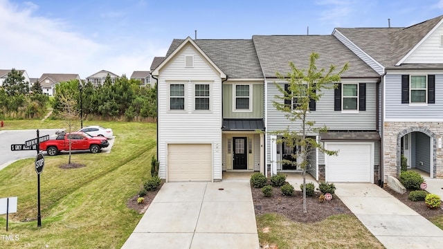 72 S Grey Abbey Dr, Clayton, NC 27527 - townhome / multi-family property with concrete driveway, an attached garage, a front lawn, stone siding, and a shingled roof