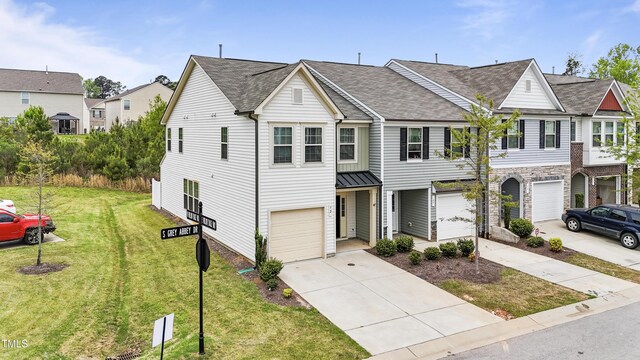 72 S Grey Abbey Dr, Clayton, NC 27527 - view of property with an attached garage, concrete driveway, a front yard, and roof with shingles