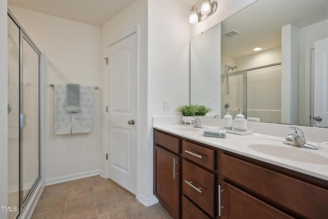 72 S Grey Abbey Dr, Clayton, NC 27527 - bathroom with a shower with door, double vanity, and baseboards